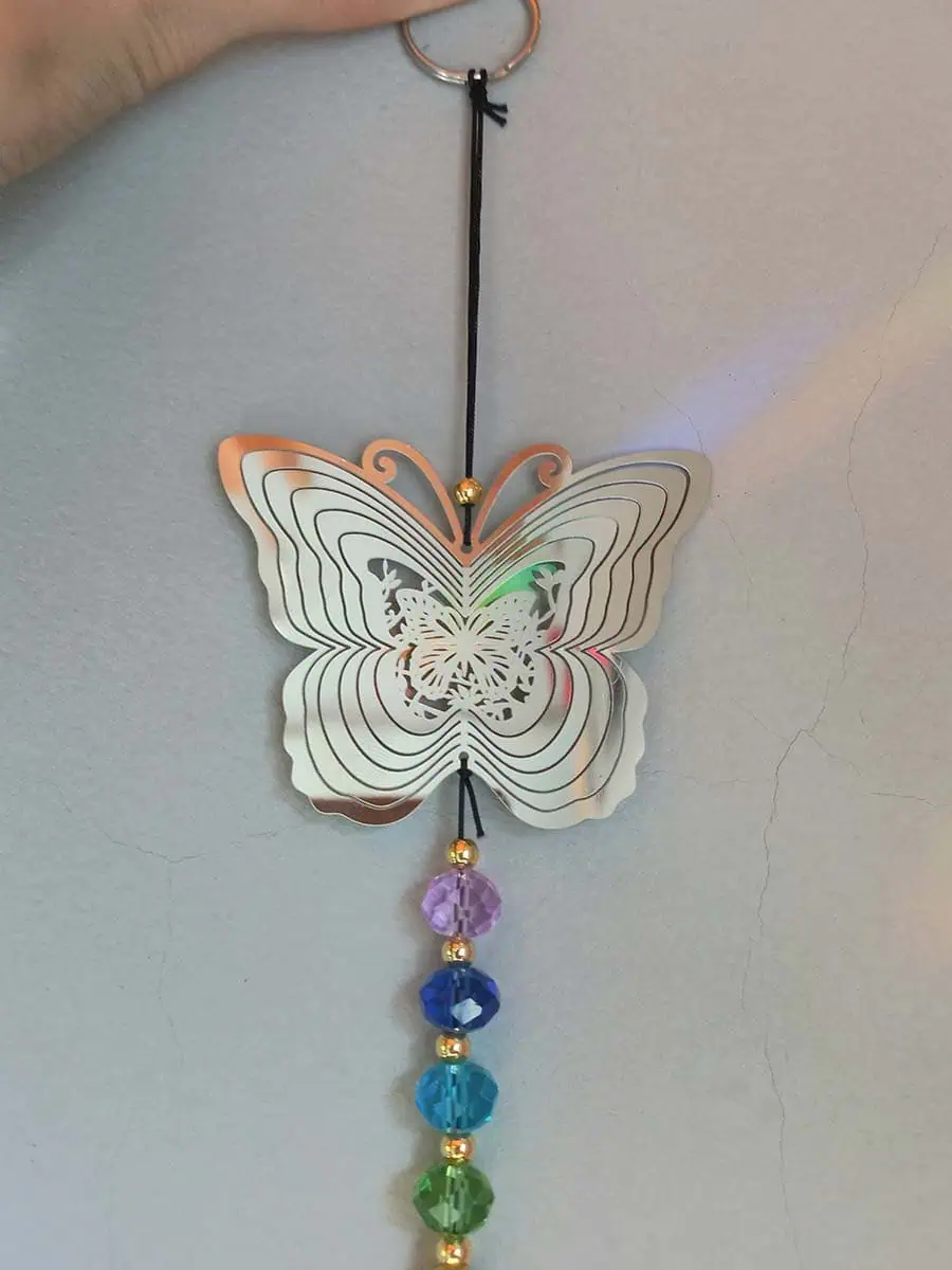 Atrapasol de acero inoxidable con mariposa y remolino decorativo