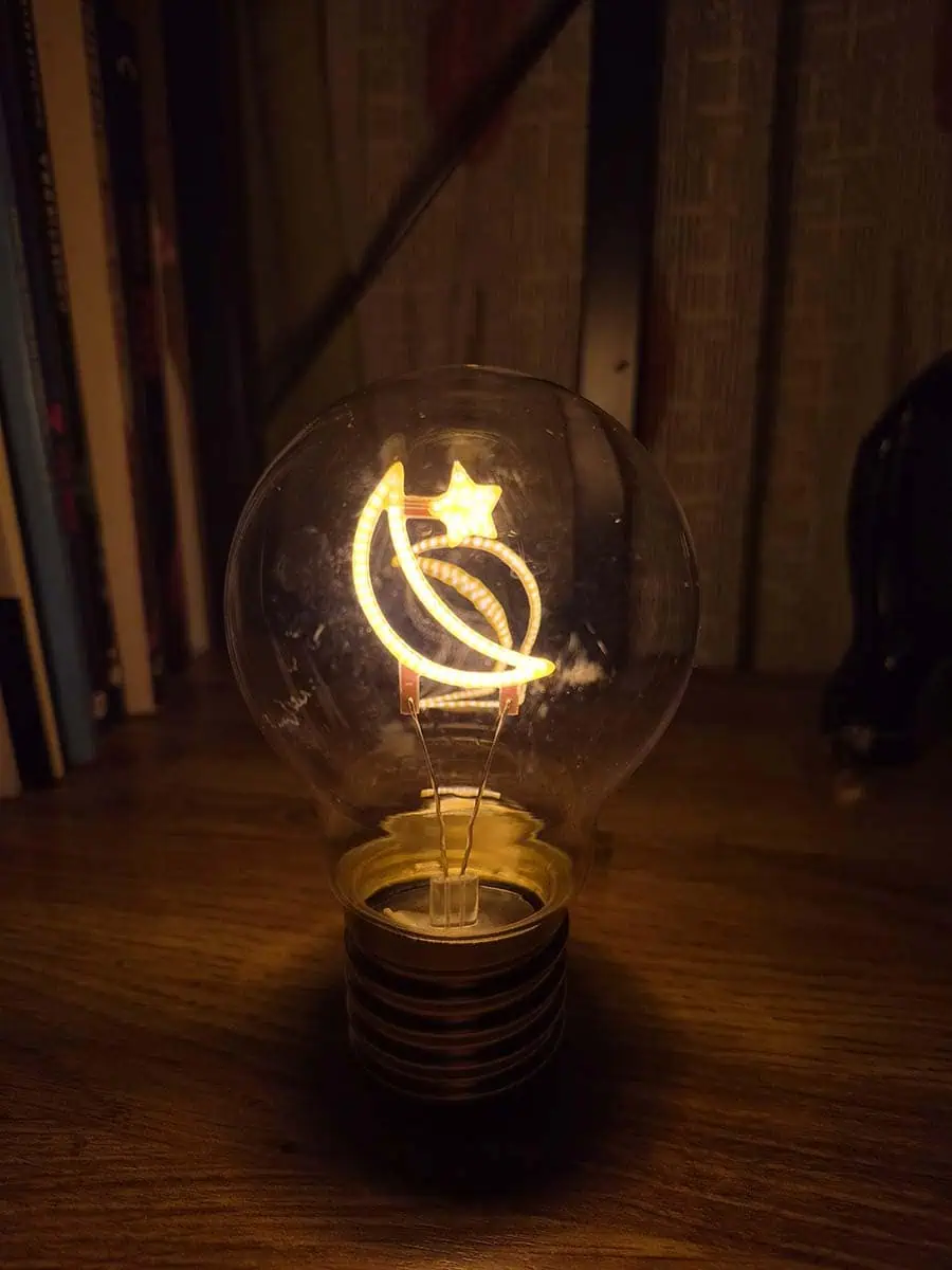 Bombilla LED decorativa con diseño de media luna y estrella iluminadas